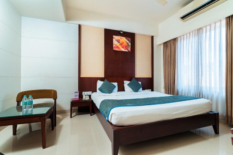 Deluxe A/C room at Hotel Chaitali showing the bed and window