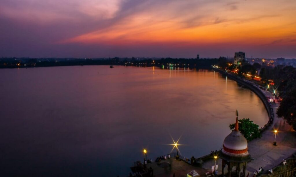 Rankala Lake at sunset with the promenade, pavilion and city lights, Kolhapur