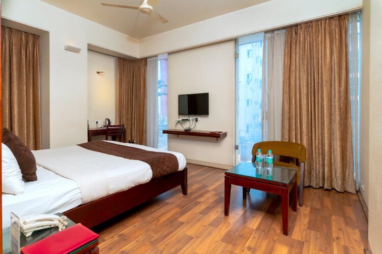 Super Deluxe room at Hotel Chaitali with seating and a work desk